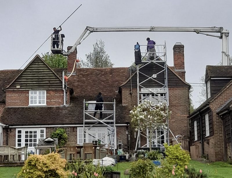 The Roof Moss Cleaners using cherry picker and scaffolding to clean roof safely and professionally in Yaxley, Cambridgeshire